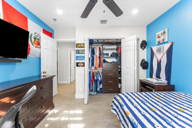 a park view with a bench under large trees