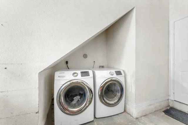 a view of a house with a yard and palm trees
