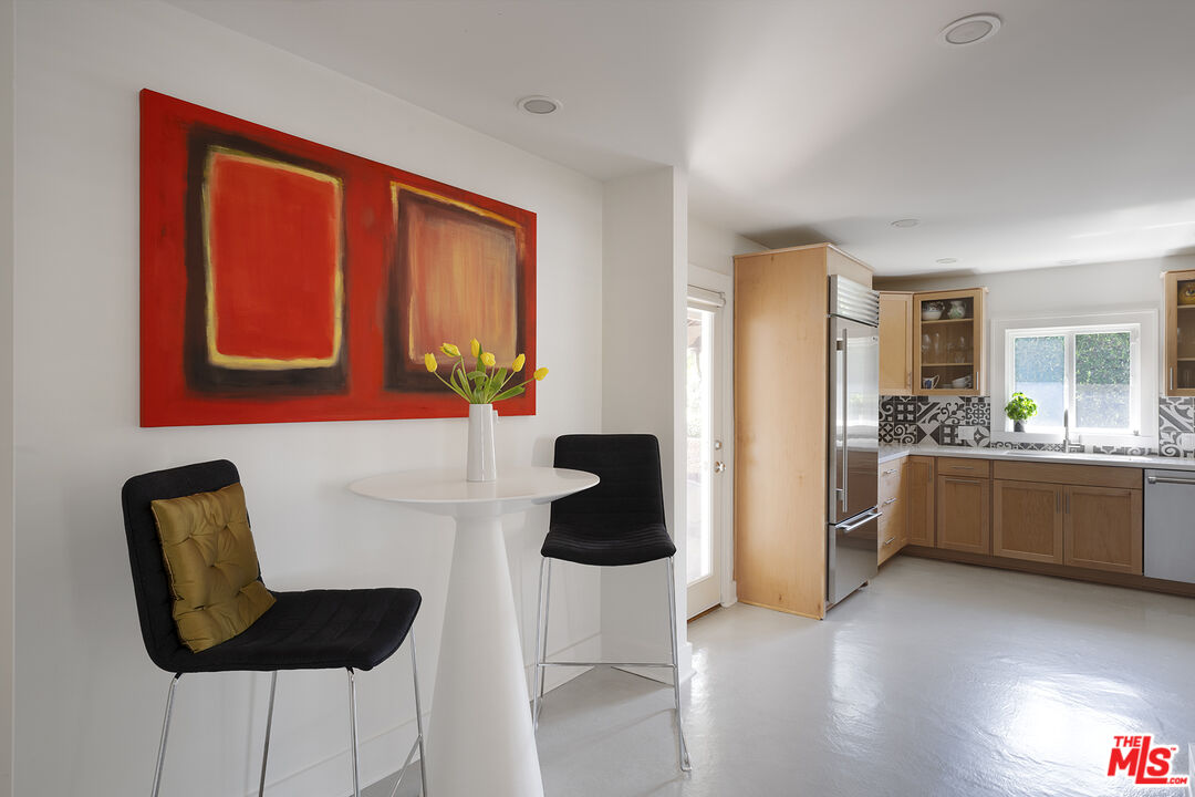 1601 Hi Point Street Los Angeles, CA 90035 - Photo 12 of 25 a kitchen with stainless steel appliances granite countertop a refrigerator a stove a microwave oven with white cabinets and wooden floor