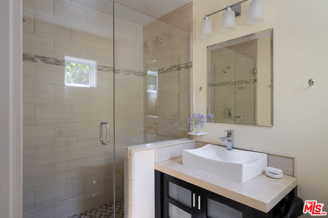 1601 Hi Point Street Los Angeles, CA 90035 - Photo 19 of 25 a bathroom with a sink shower and a mirror