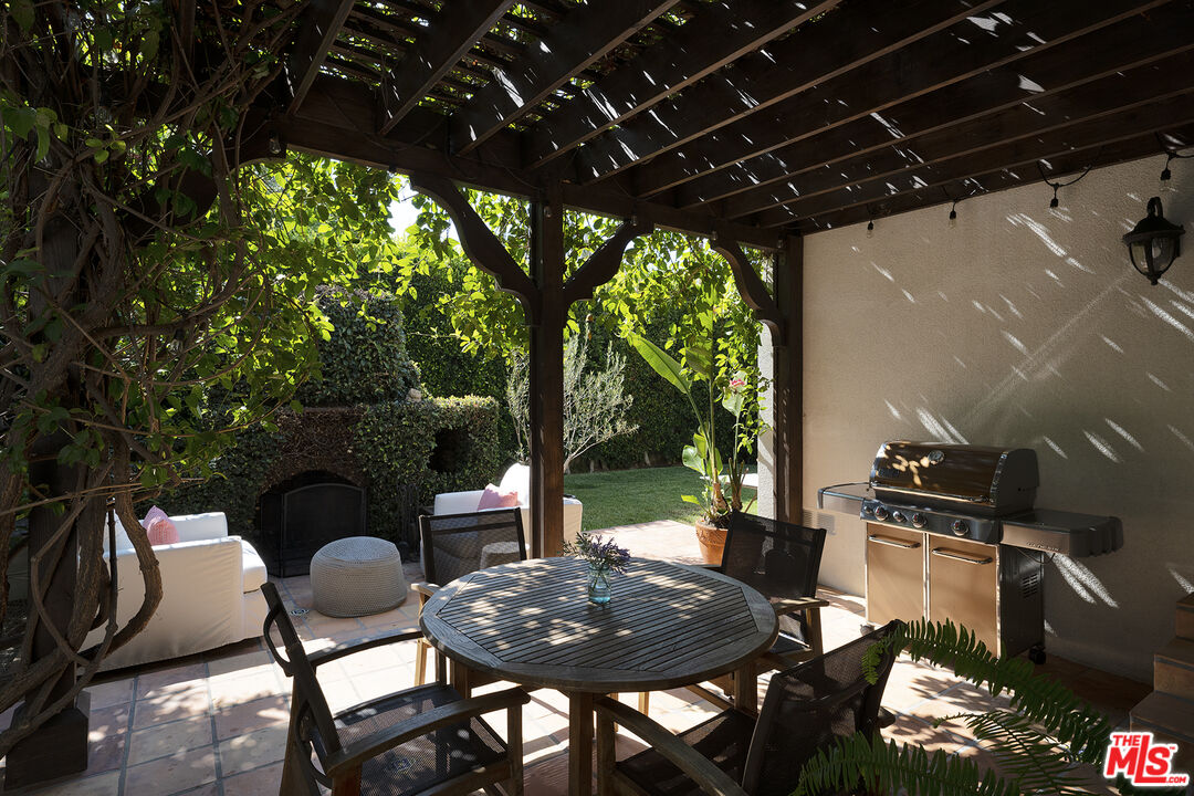 1601 Hi Point Street Los Angeles, CA 90035 - Photo 23 of 25 a backyard of a house with table and chairs