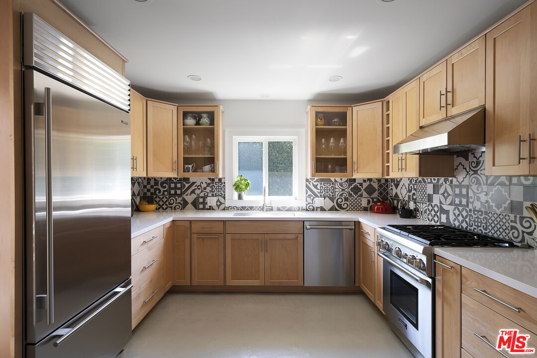 1601 Hi Point Street Los Angeles, CA 90035 - Photo 10 of 25 a kitchen with stainless steel appliances granite countertop a sink and a refrigerator