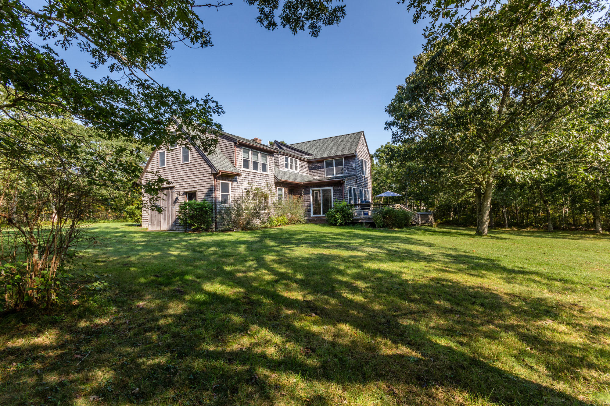 321 Chappaquiddick Road Edgartown, MA 02539 - Photo 2 of 35 a view of a big house with a big yard and large trees
