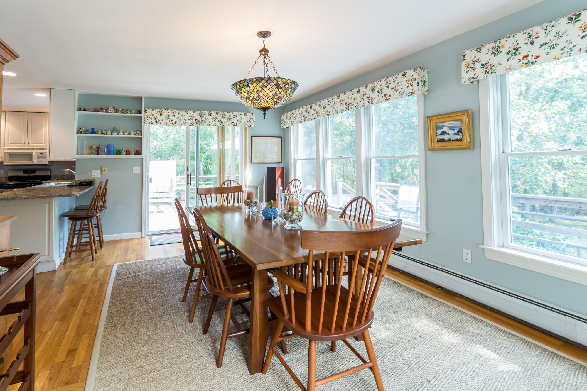 321 Chappaquiddick Road Edgartown, MA 02539 - Photo 7 of 35 a view of a dining room with furniture a chandelier and wooden floor