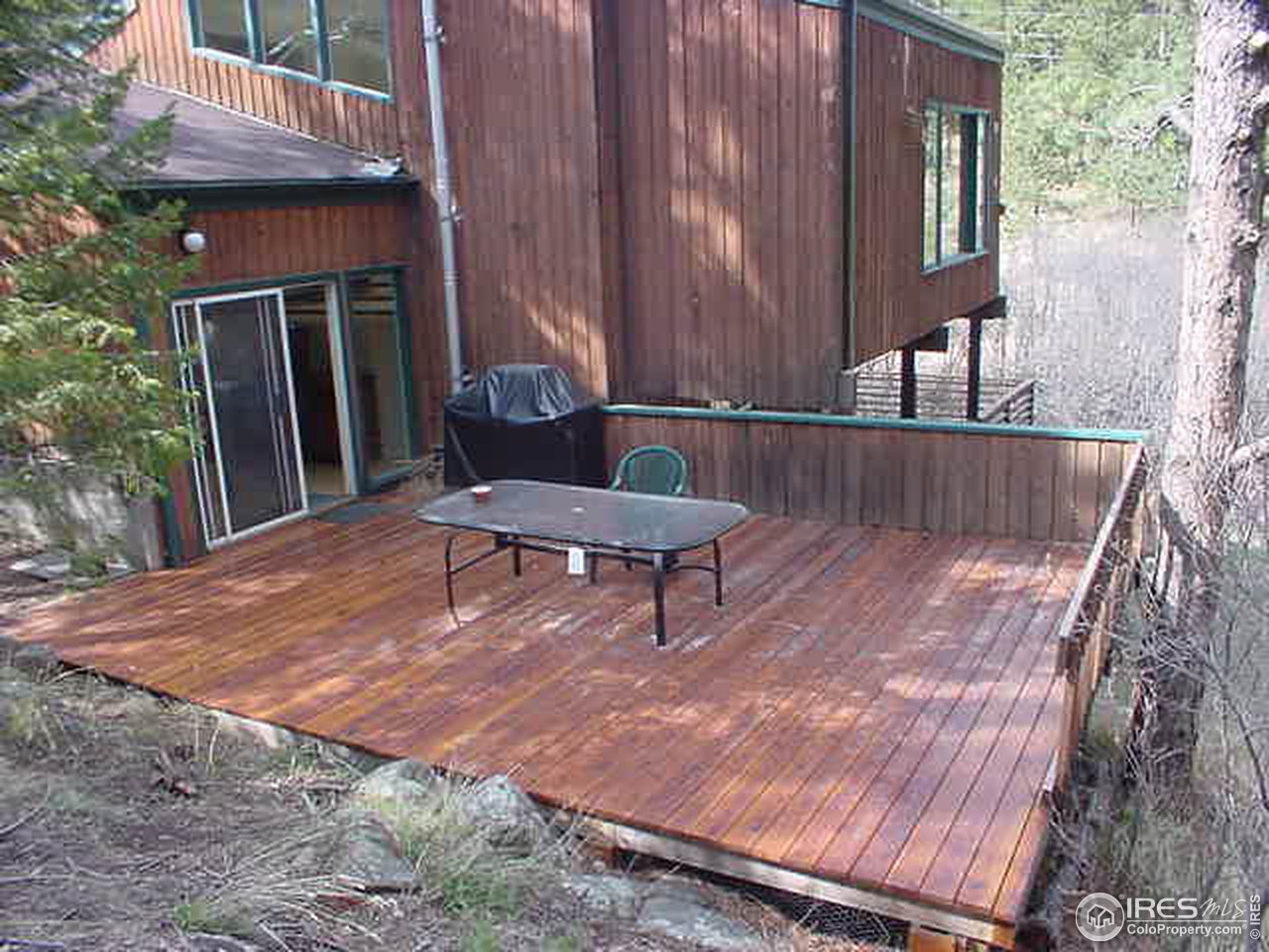 60 Spring Lane Boulder, CO 80302 - Photo 5 of 5 a wooden bench sitting in front of a building