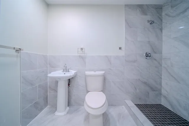 a bathroom with a sink toilet and a shower
