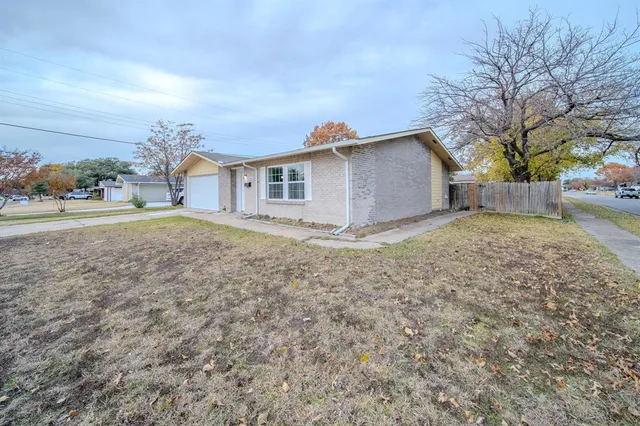 a white house that has a tree in front of it