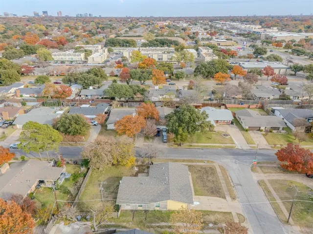 an aerial view of residential houses with outdoor space