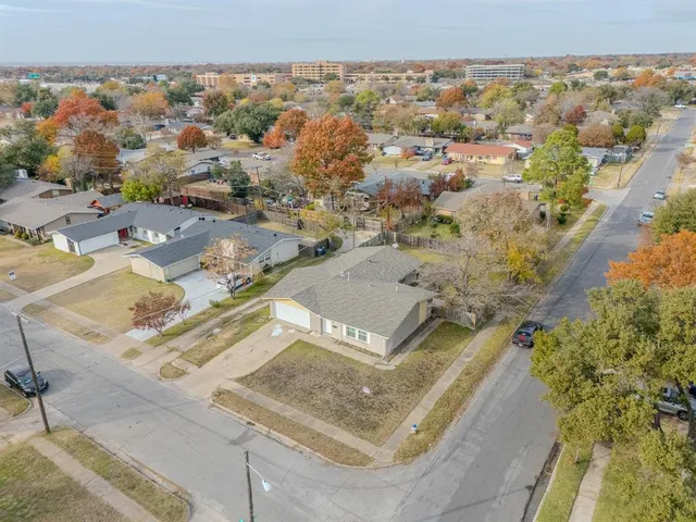 an aerial view of residential houses with outdoor space