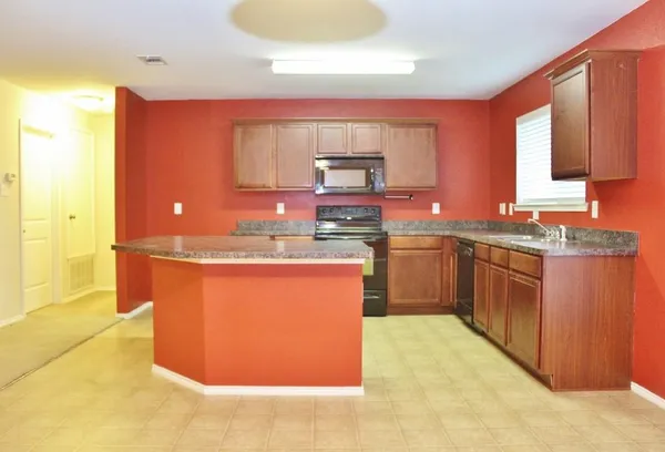 a kitchen with granite countertop sink and cabinets