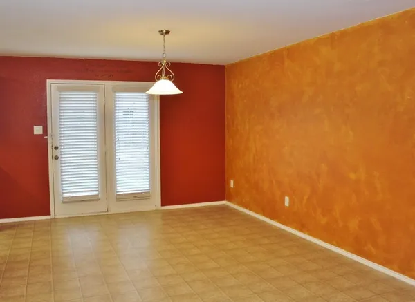 a view of a room with wooden floor and a window