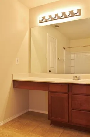 a bathroom with a double vanity sink and mirror