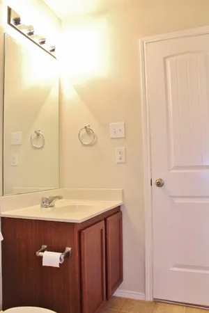 a view of a room with wooden floor and a window