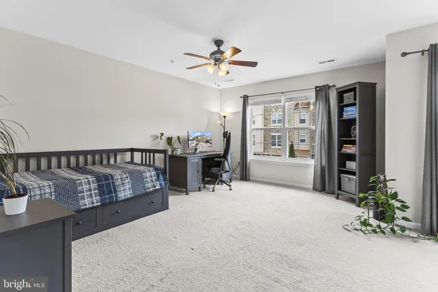 a view of a livingroom with furniture and a ceiling fan