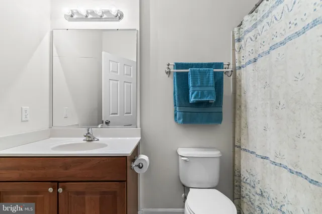 a bathroom with a sink a toilet and mirror