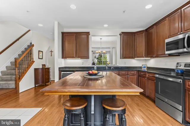 a kitchen with stainless steel appliances a stove a sink and a microwave
