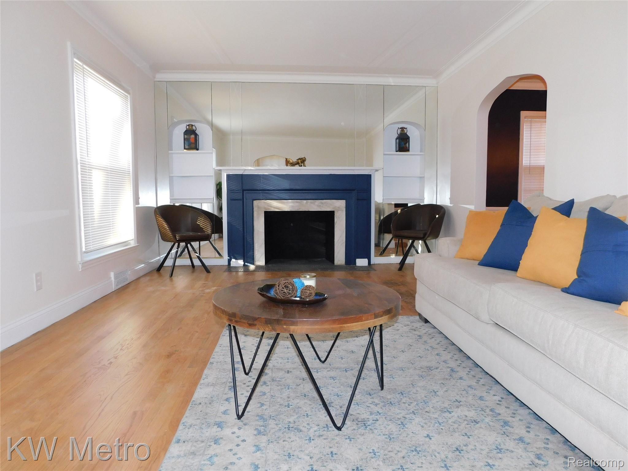 12850 Rutland Street Detroit, MI 48227 - Photo 2 of 14 Living room w/natural fireplace & built-in shelving