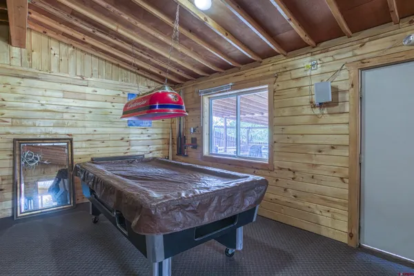a room with stainless steel appliances kitchen island granite countertop lots of counter and windows