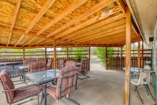 a view of a patio with a table and chairs