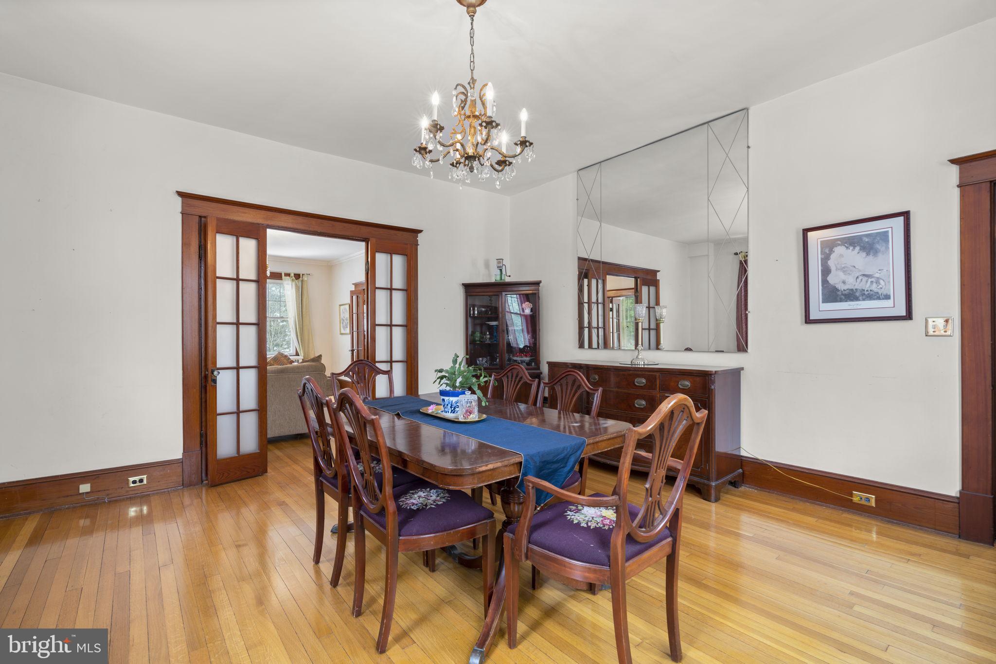 6100 Frederick Road Catonsville, MD 21228 - Photo 12 of 61 a view of a dining room with furniture a chandelier and wooden floor