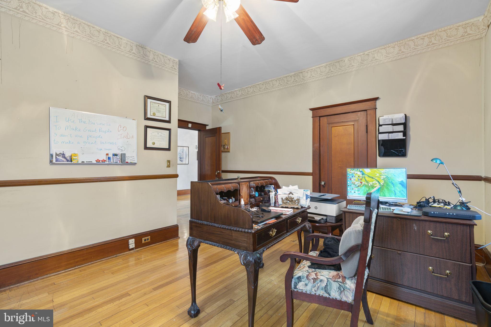 6100 Frederick Road Catonsville, MD 21228 - Photo 15 of 61 a work room with furniture and a wooden floor