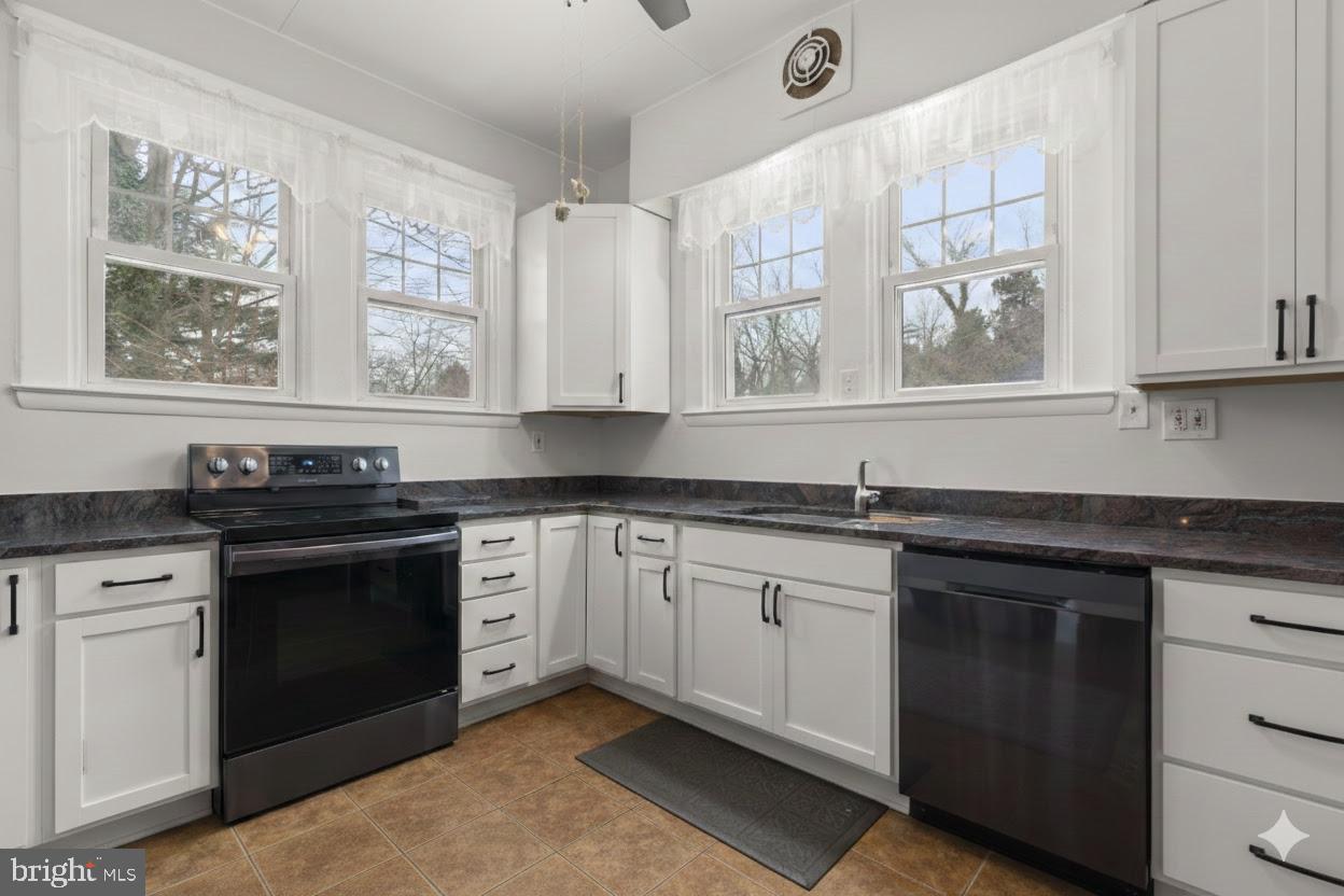 6100 Frederick Road Catonsville, MD 21228 - Photo 16 of 61 a kitchen with stainless steel appliances granite countertop a stove a sink and a microwave