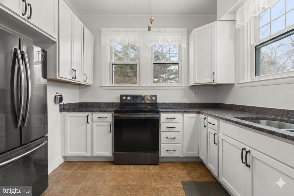 6100 Frederick Road Catonsville, MD 21228 - Photo 17 of 61 a kitchen with granite countertop white cabinets white stainless steel appliances and a sink