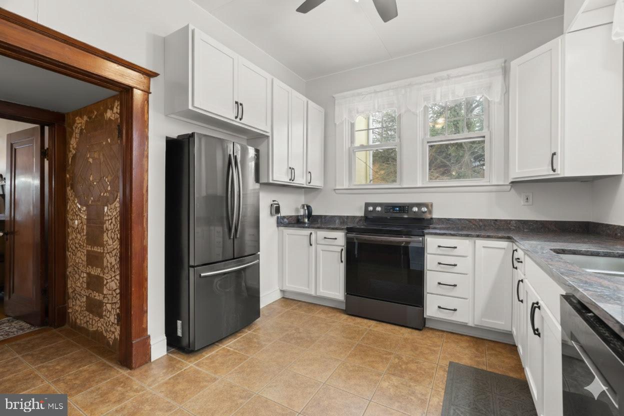6100 Frederick Road Catonsville, MD 21228 - Photo 18 of 61 a kitchen with stainless steel appliances granite countertop a stove a refrigerator and a sink