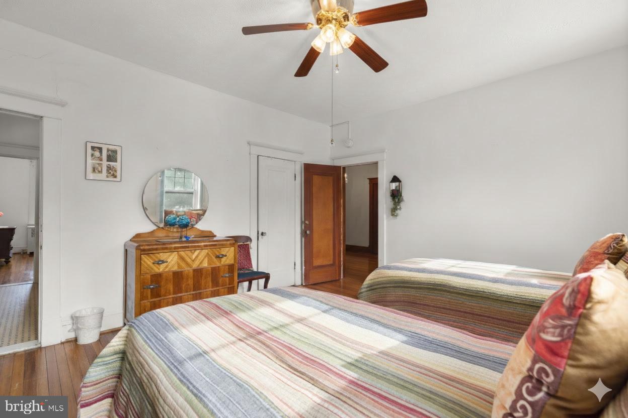 6100 Frederick Road Catonsville, MD 21228 - Photo 27 of 61 a bedroom with a bed and wooden floor