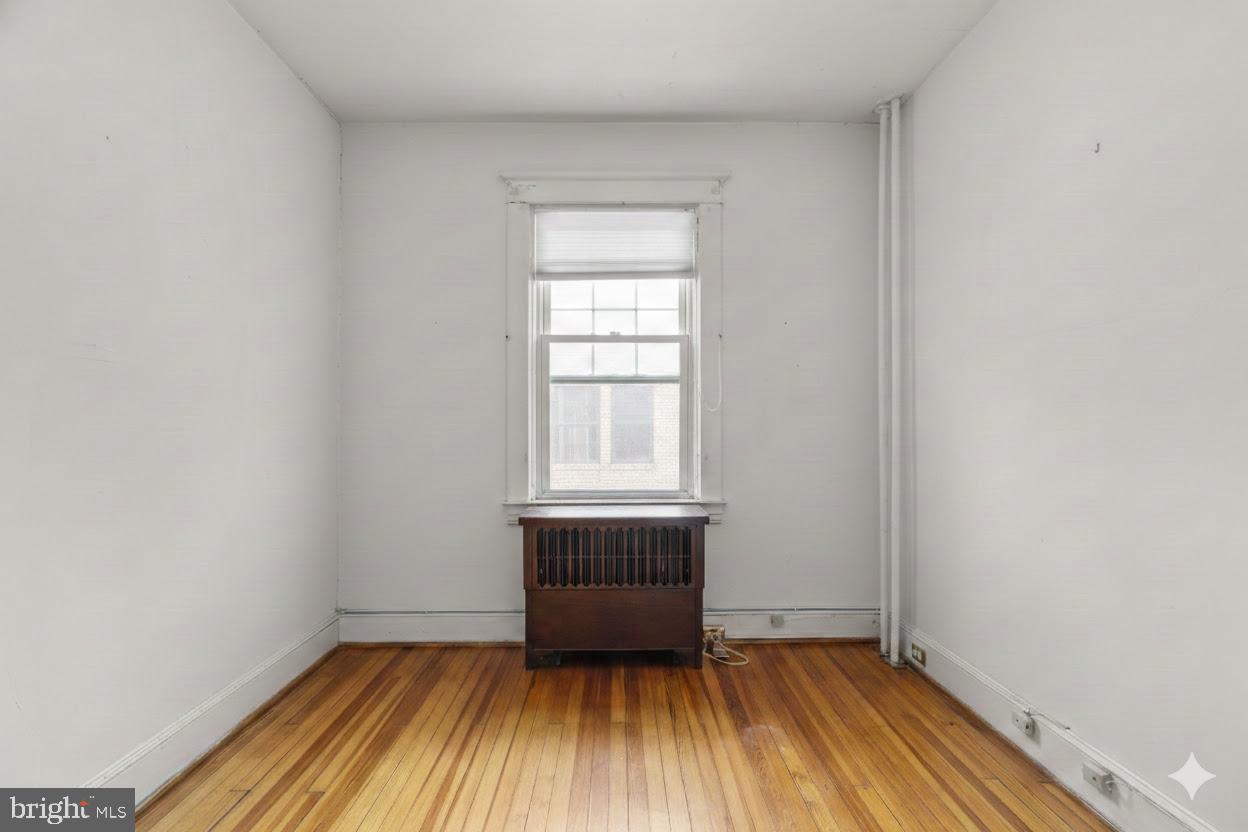 6100 Frederick Road Catonsville, MD 21228 - Photo 28 of 61 a view of an empty room with wooden floor and a window