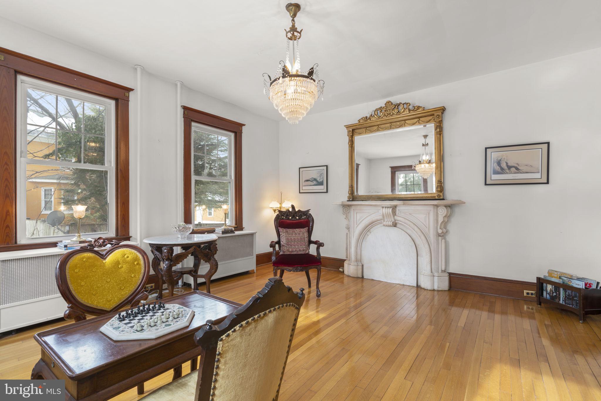 6100 Frederick Road Catonsville, MD 21228 - Photo 3 of 61 a living room with furniture a table and chair with wooden floor