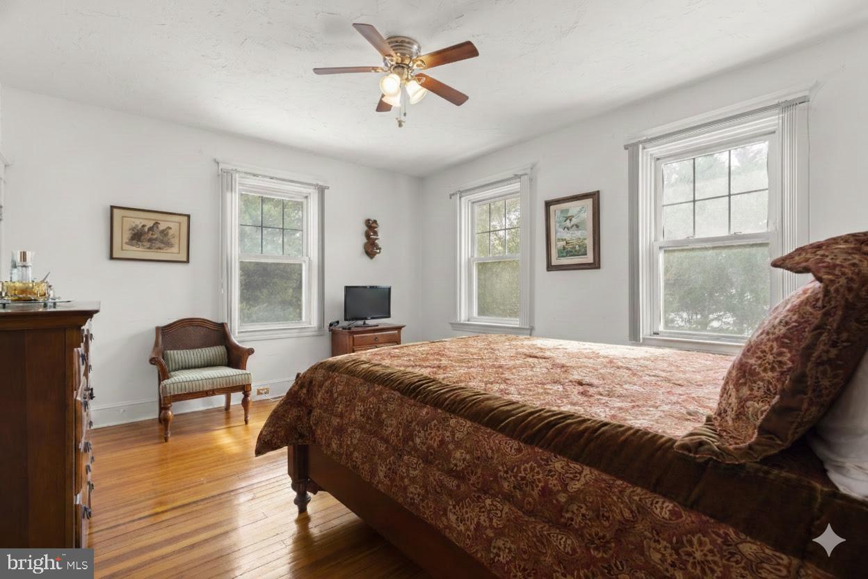 6100 Frederick Road Catonsville, MD 21228 - Photo 31 of 61 a bedroom with a bed and wooden floor