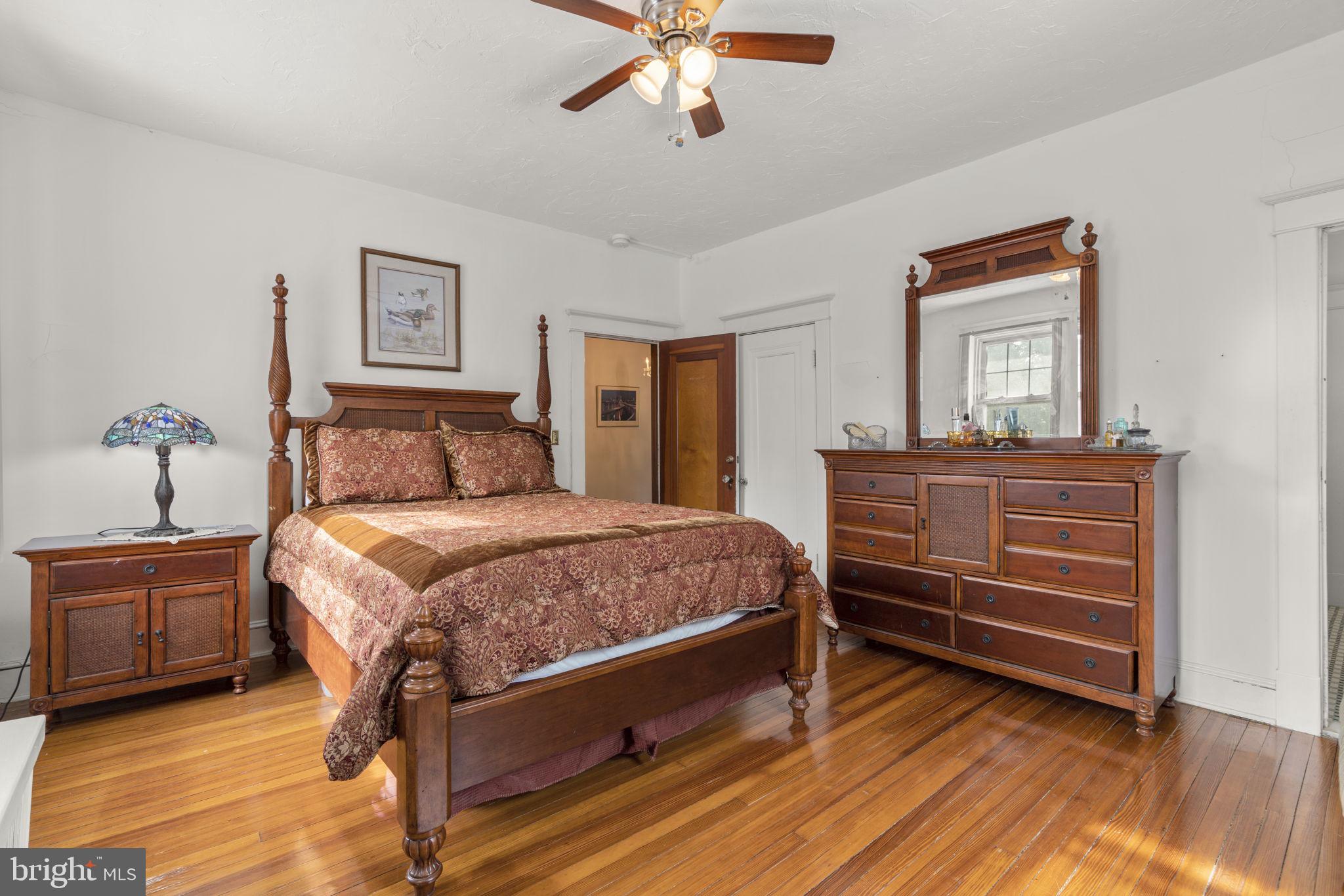 6100 Frederick Road Catonsville, MD 21228 - Photo 32 of 61 a bedroom with a bed and a chandelier