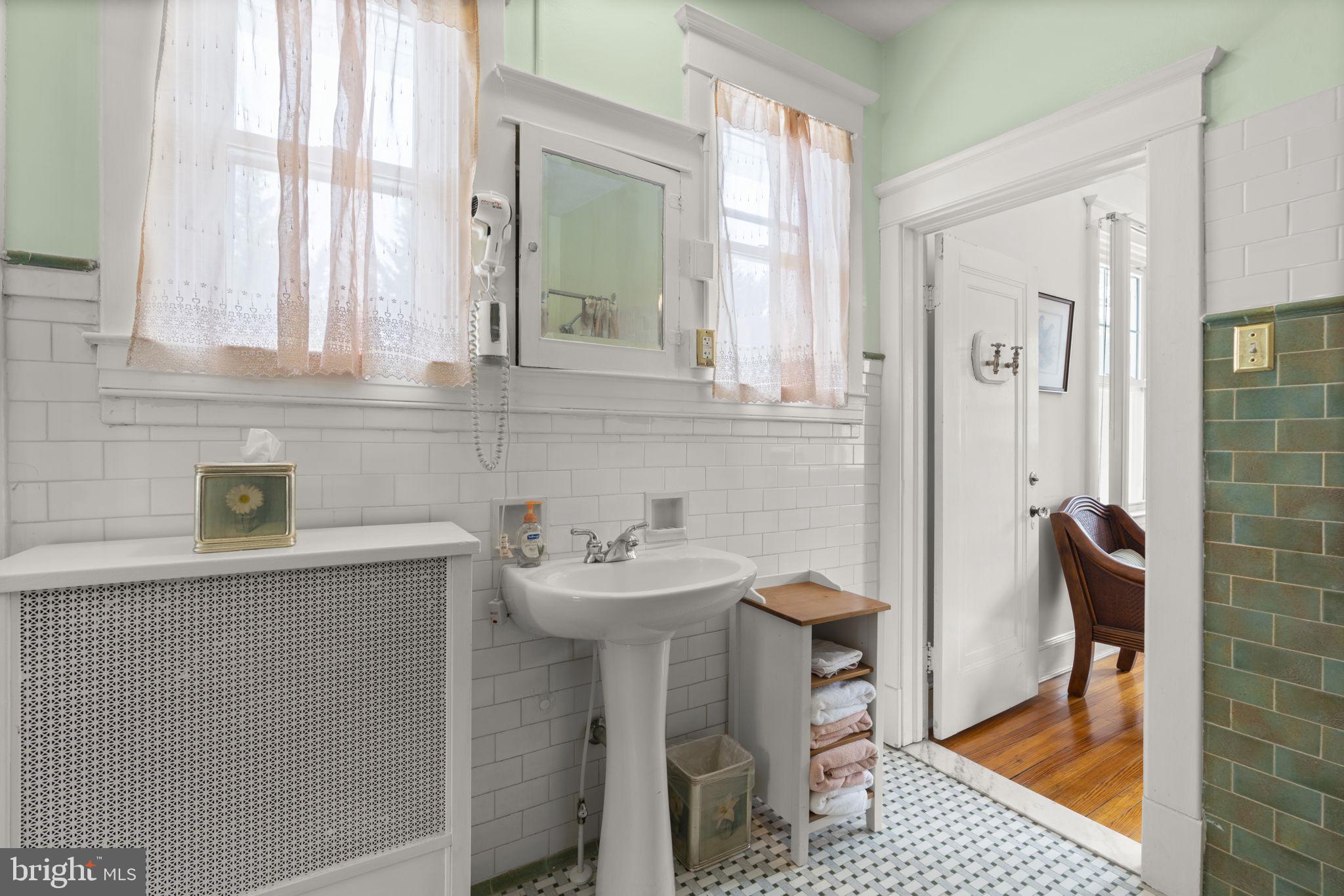 6100 Frederick Road Catonsville, MD 21228 - Photo 34 of 61 a bathroom with a sink a toilet and a window