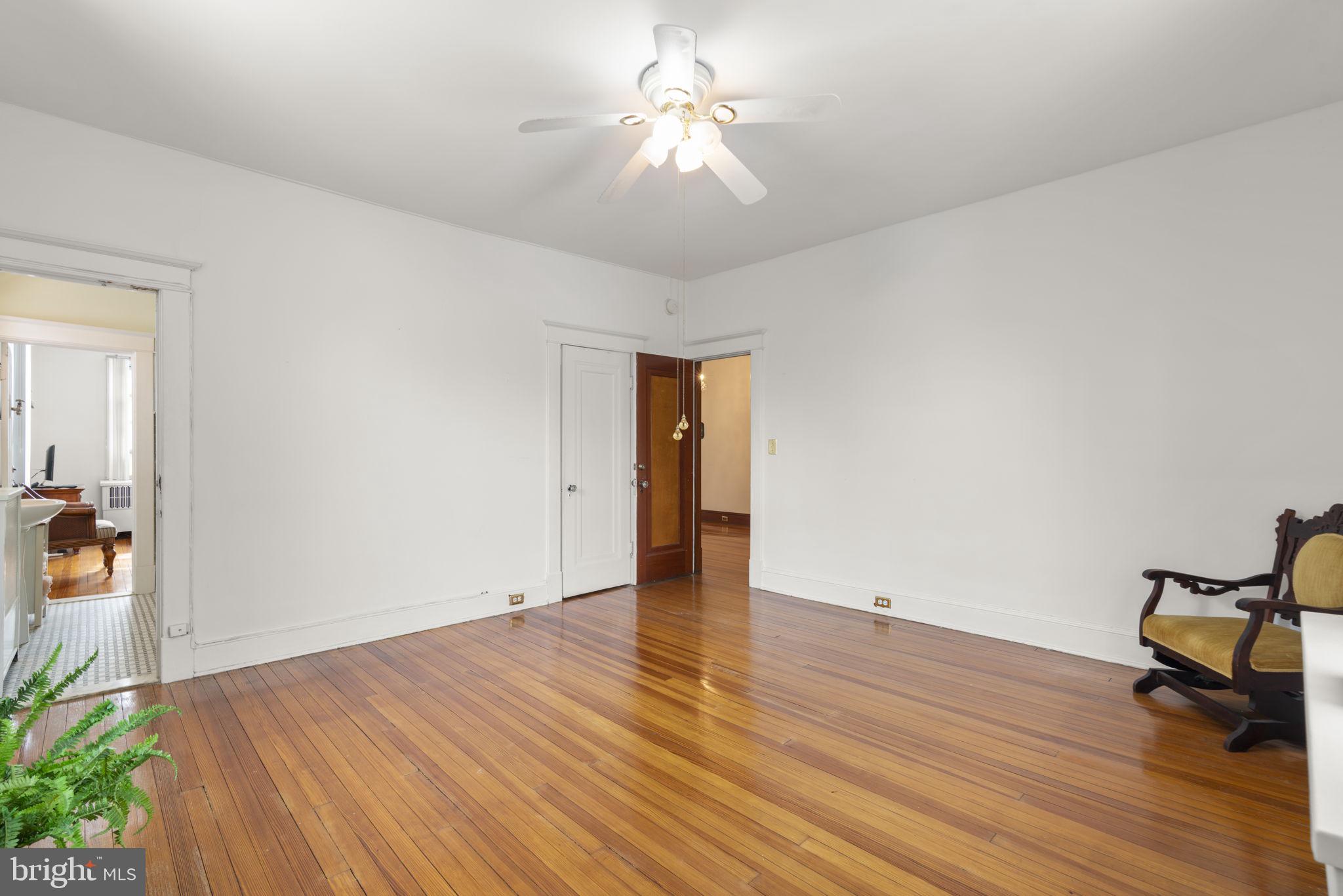 6100 Frederick Road Catonsville, MD 21228 - Photo 36 of 61 a view of an empty room with wooden floor and a ceiling fan