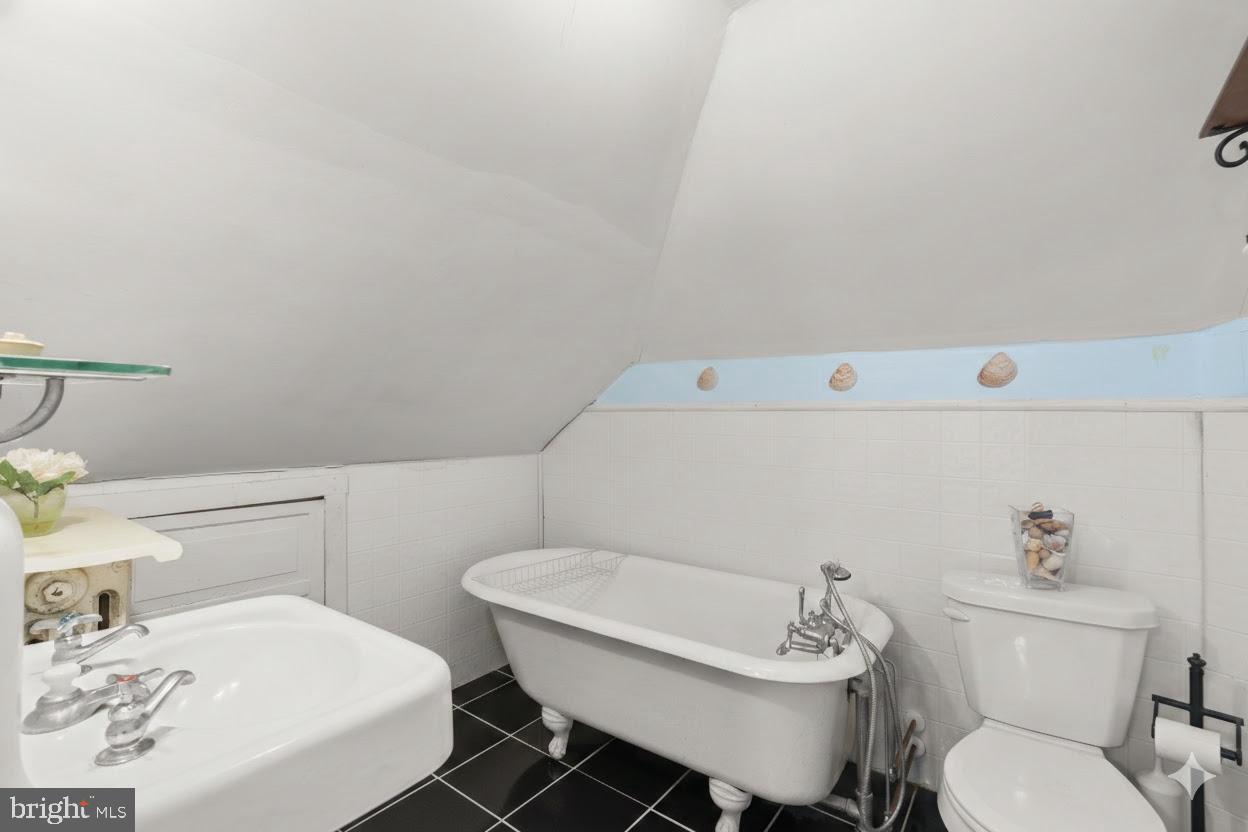 6100 Frederick Road Catonsville, MD 21228 - Photo 38 of 61 a bathroom with a sink a toilet and a mirror