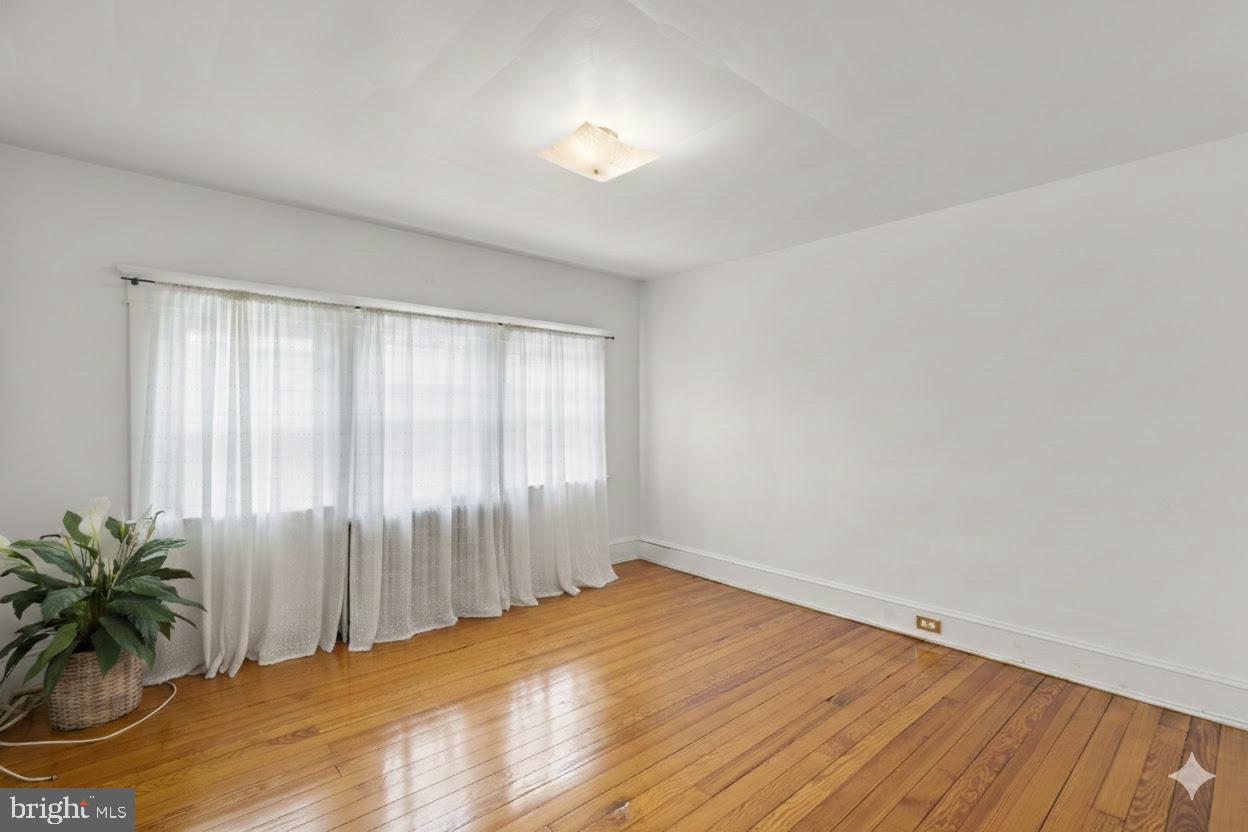 6100 Frederick Road Catonsville, MD 21228 - Photo 40 of 61 an empty room with window and wooden floor