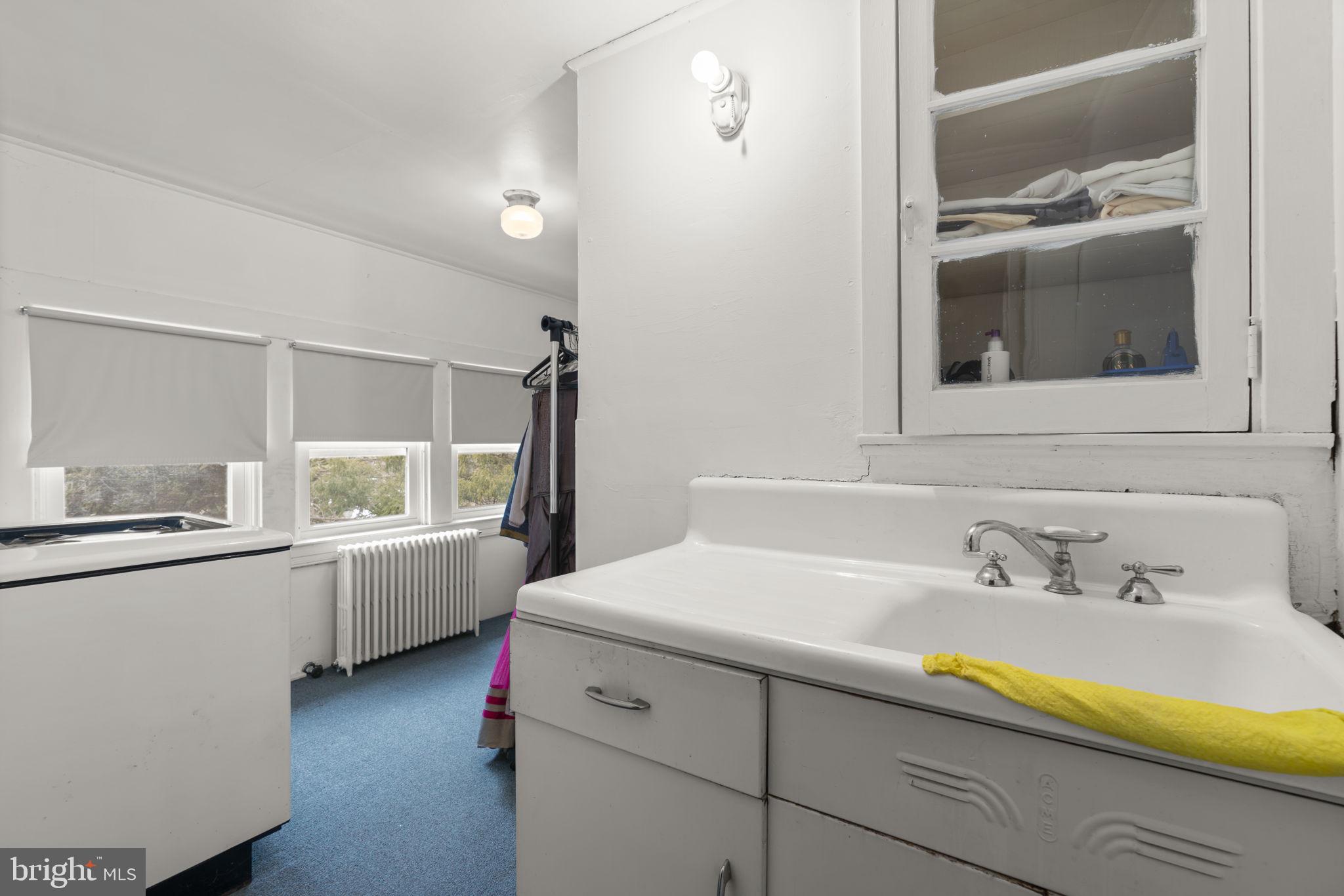 6100 Frederick Road Catonsville, MD 21228 - Photo 45 of 61 a bathroom with a sink and a mirror