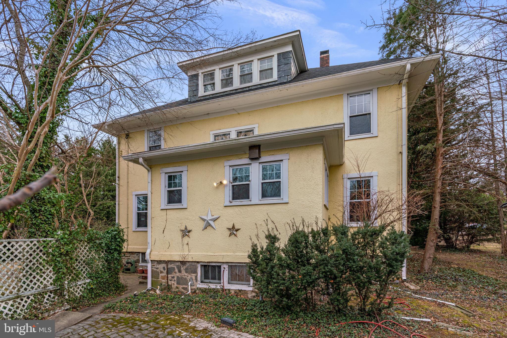 6100 Frederick Road Catonsville, MD 21228 - Photo 51 of 61 a front view of house with yard and trees around