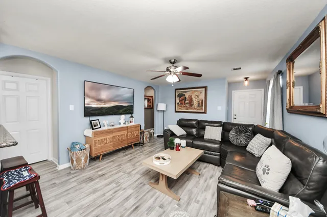 a living room with furniture and a flat screen tv