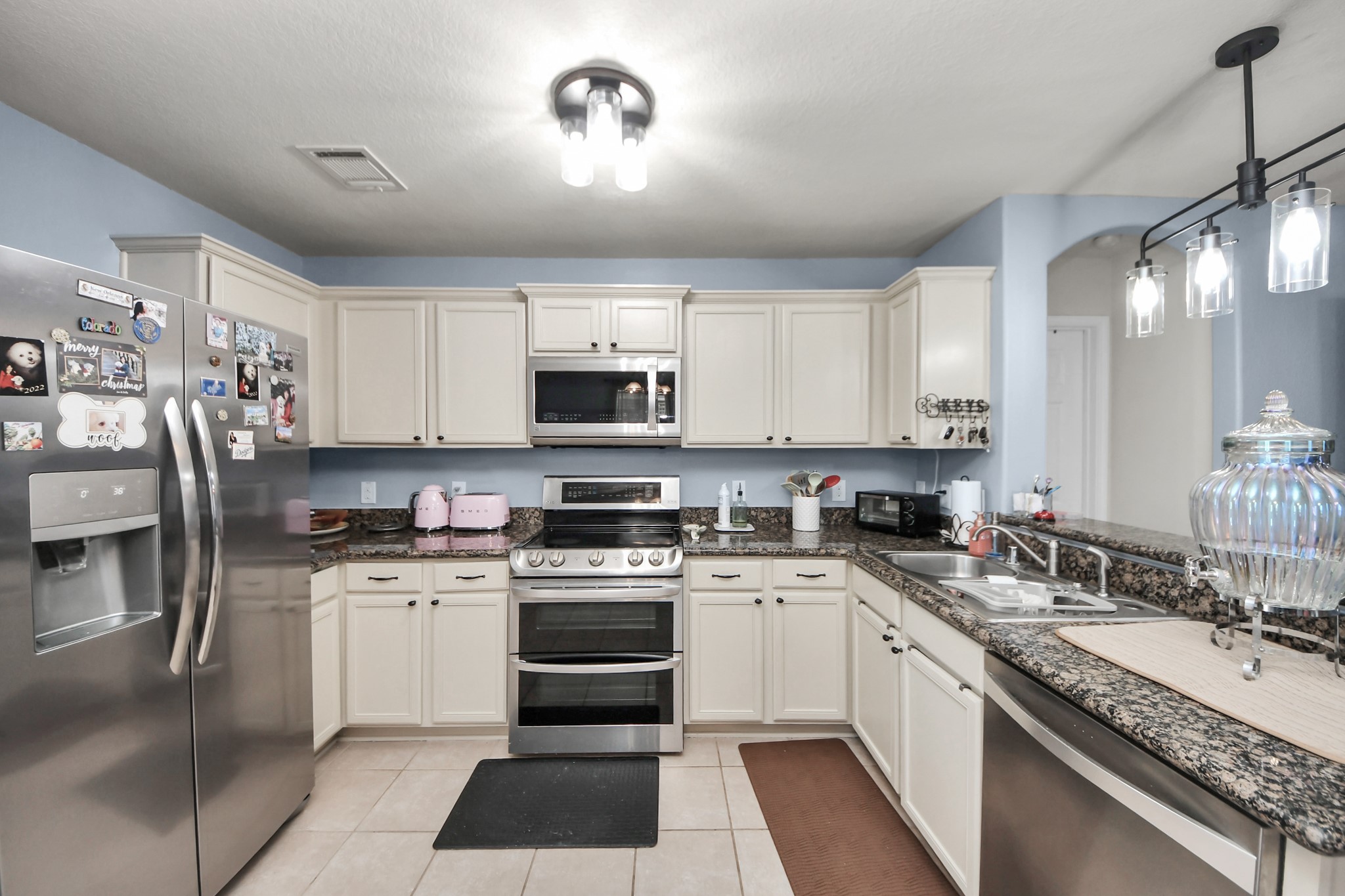 28961 San Bernard River Loop Spring, TX 77386 - Photo 17 of 36 a kitchen with a sink stainless steel appliances and white cabinets