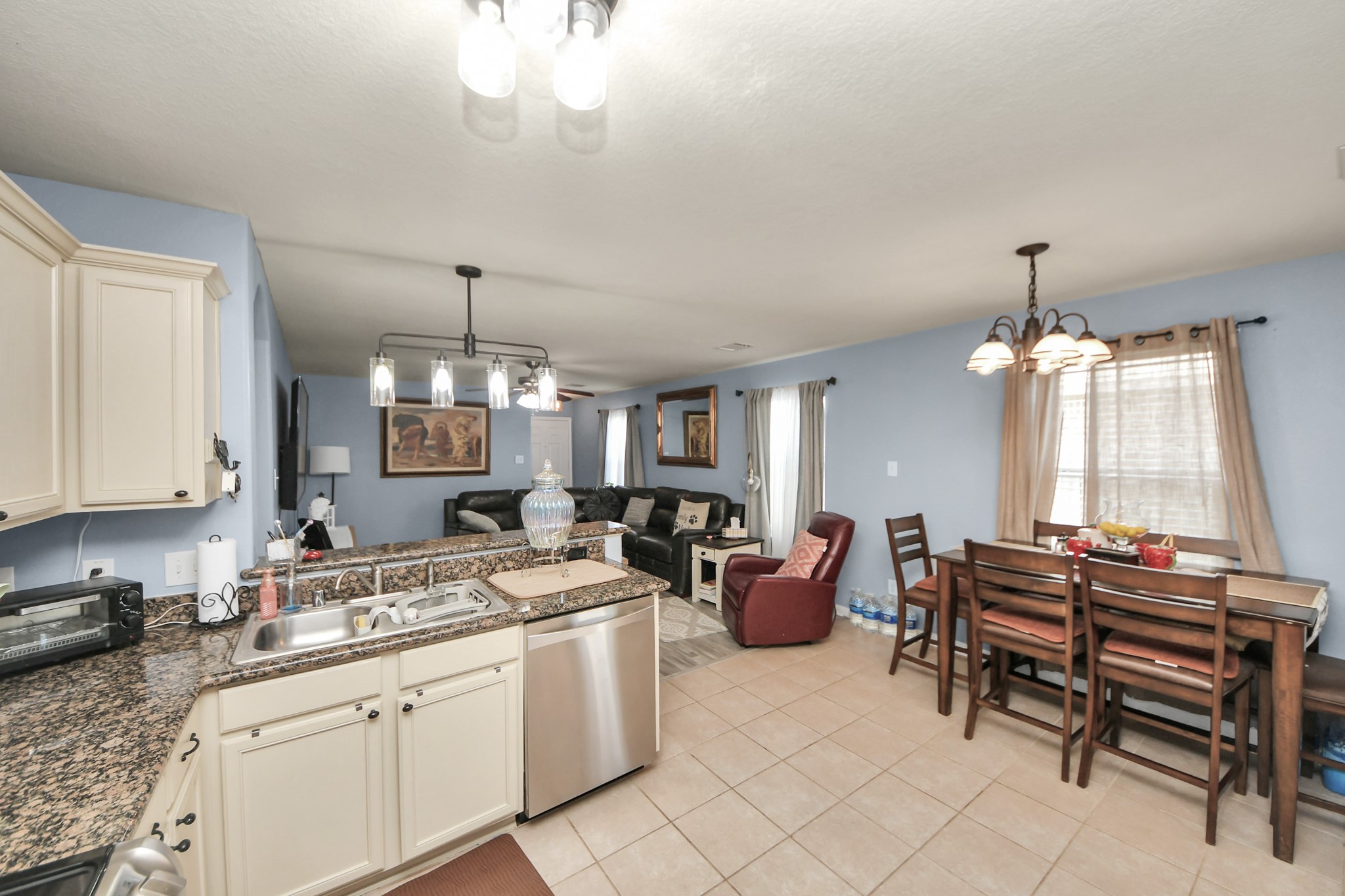 28961 San Bernard River Loop Spring, TX 77386 - Photo 18 of 36 a kitchen that has a cabinets counter space dining table and a chandelier