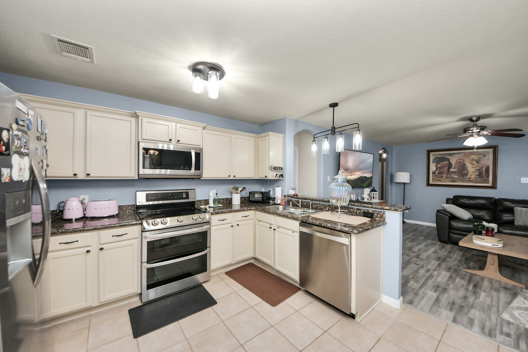 28961 San Bernard River Loop Spring, TX 77386 - Photo 20 of 36 a kitchen with stainless steel appliances granite countertop a stove top oven a sink dishwasher and white cabinets