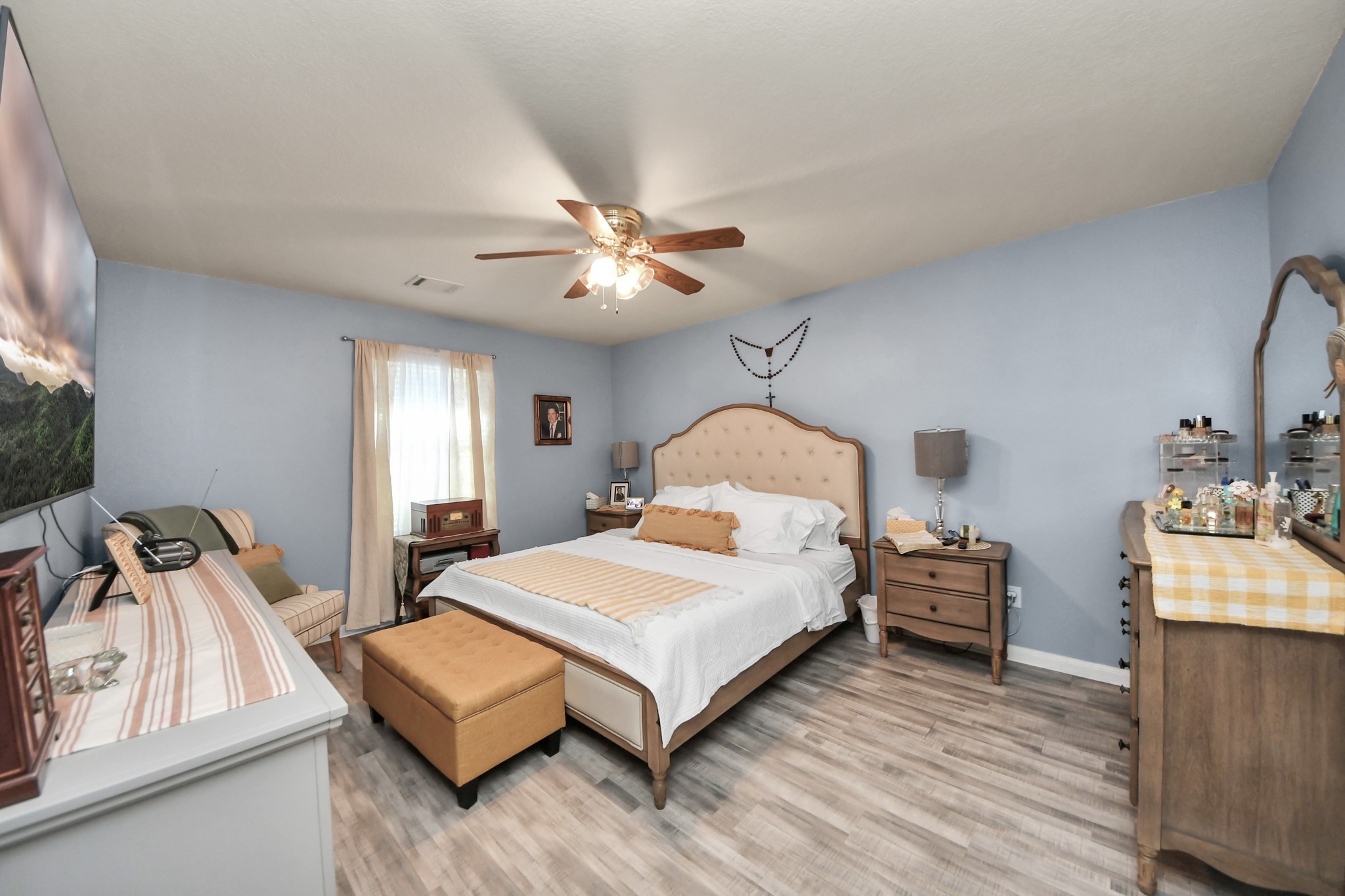 28961 San Bernard River Loop Spring, TX 77386 - Photo 21 of 36 a bedroom with a bed and a chandelier