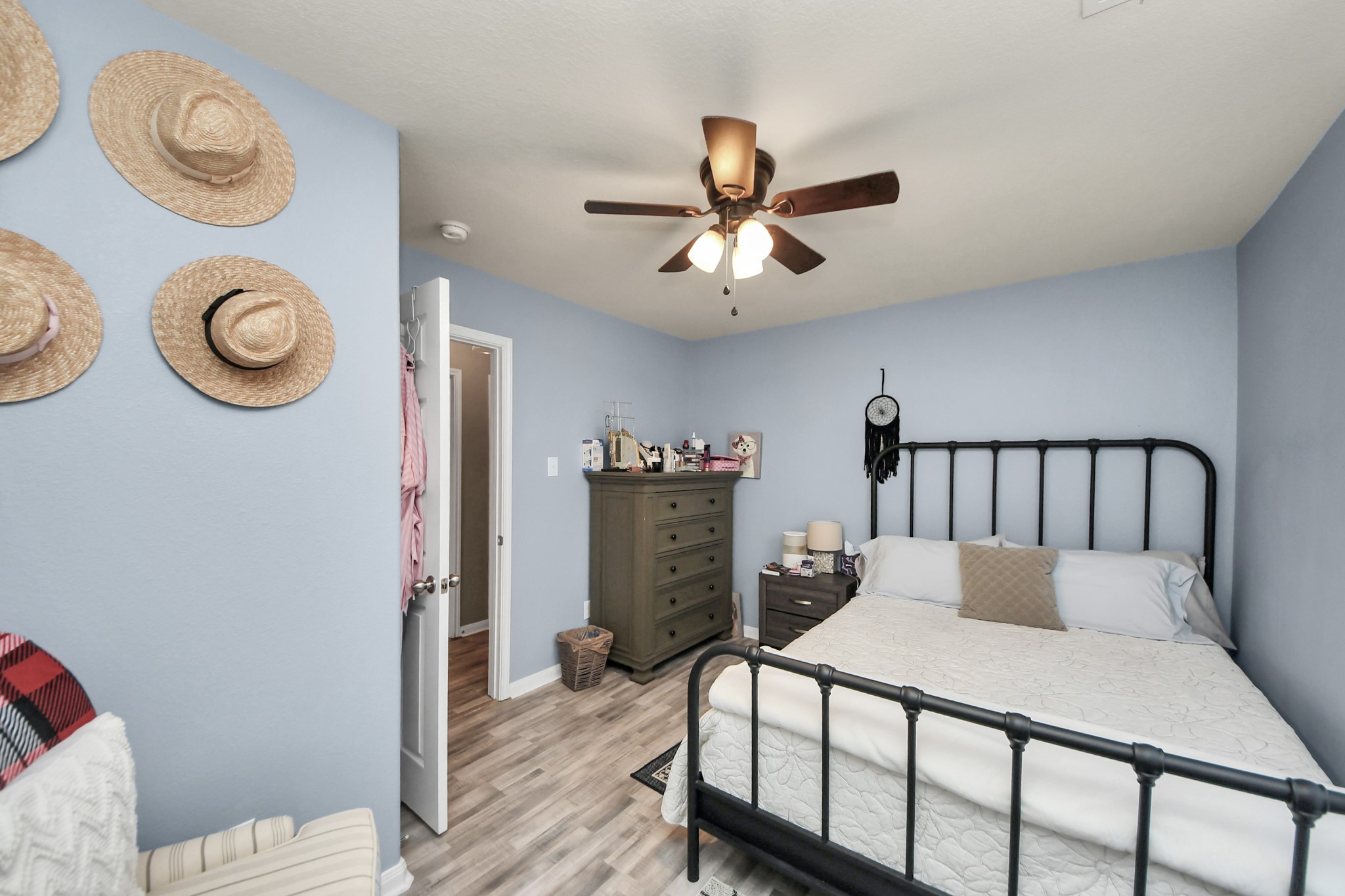 28961 San Bernard River Loop Spring, TX 77386 - Photo 26 of 36 a bedroom with a bed and a chandelier