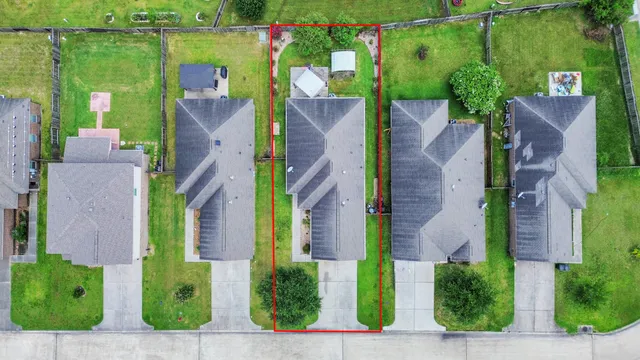 an aerial view of a house with a yard basket ball court and outdoor seating