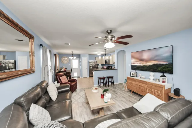 a living room with furniture and a flat screen tv