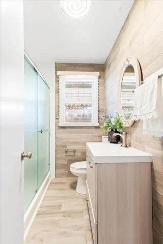 a bathroom with a sink a toilet and shower