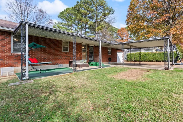 a view of a house with a yard porch and sitting area