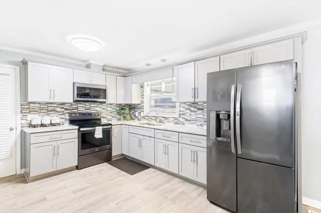 a kitchen with a refrigerator sink and microwave